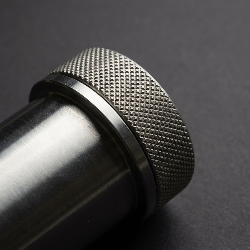 Macro detail of the diamond-knurled stainless steel cap